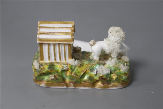 A rare Staffordshire porcelain figure a poodle outside its kennel, c.1835-50, attributed to Lloyd Shelton, L. 8cm